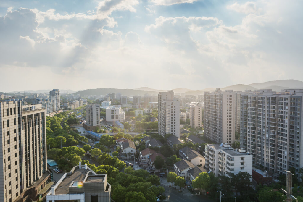 Densely developed urban residential area featuring high-rise apartments and integrated green spaces.