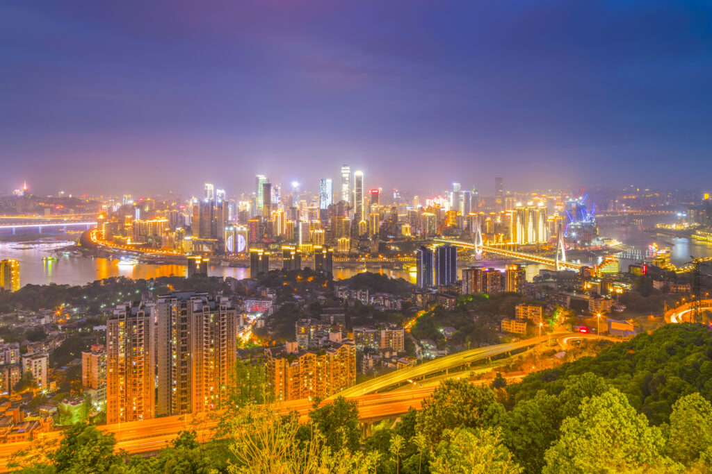 Night skyline depicting large-scale urban development with transport connectivity and high-rise housing